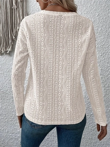 Detail shot of white lace hollowed-out fabric with vertical geometric patterns on back
