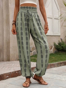 Detail of bohemian geometric print harem pants with elastic high waist and drawstring