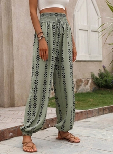 Close-up of bohemian high-waisted harem pants with geometric patterns and drawstring waist