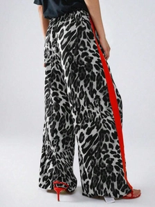 Detail der Leoparden-Hose mit weitem Bein, roten Seitenstreifen und elastischem Bund