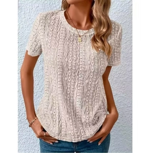 Detail of white hollow-out lace texture and geometric crochet patterns on short sleeve top