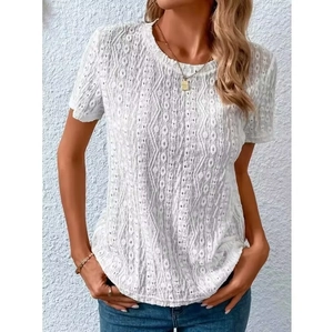 Detail of white short sleeve top featuring hollow eyelet geometric textured patterns