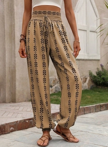 Detail of high waisted smocked waist with drawstring on geometric print lantern pants