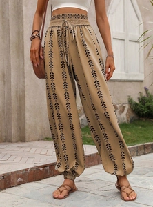 Detail of high waisted harem pants with geometric prints and elastic drawstring waist