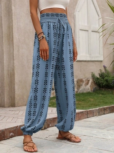 Detailed view of women's high-waisted harem pants with blue geometric tribal patterns