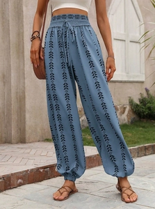 Detail of high waist bohemian lantern pants with geometric print and elastic drawstring