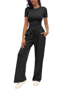 Detail view of black pleated short sleeve top and drawstring wide leg trousers lounge set