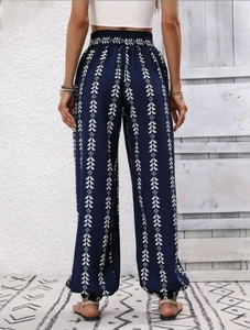 Detail view of ethnic geometric print on bohemian harem pants with elastic high waist