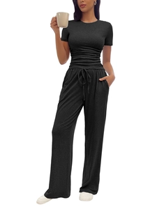 Close-up of black short sleeve top and drawstring wide-leg pants in soft ribbed knit