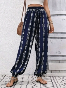 Detail of high waisted boho jogger pants with blue geometric print and drawstring waist
