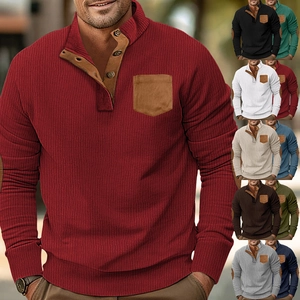 Detail of waffle-knit polo shirt with brown contrast collar and chest pocket details