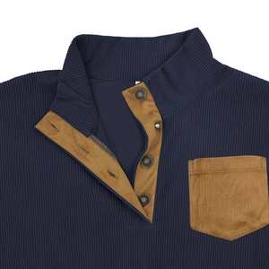 Close-up of a men's navy corduroy sweatshirt with contrast brown pocket and metal buttons
