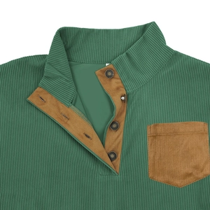 Detailed view of dark green ribbed knit fabric with brown pocket and button placket