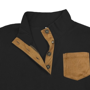 Detail of black corduroy sweatshirt featuring brown suede pocket and metal snap buttons