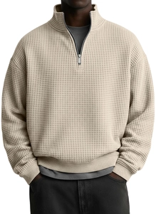 Detailed view of oatmeal waffle knit fabric texture and half-zip collar on men's pullover