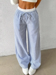 Detail of blue striped wide-leg pants featuring elastic waistband and adjustable drawstring