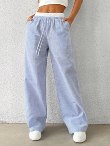 Detail of blue and white vertical striped wide-leg trousers with elastic drawstring waist