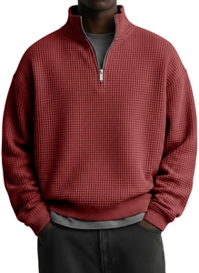 Macro view of the deep red waffle knit texture and premium metal quarter-zip collar detail