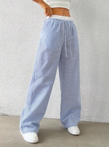 Detail of blue and white vertical striped wide-leg pants with elastic drawstring waist