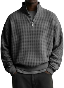 Macro shot of dark grey waffle knit fabric texture on half-zip polo sweatshirt