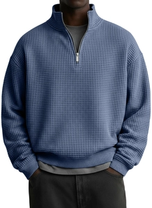 Close-up of gray-blue waffle texture fabric on a men's half-zip polo shirt