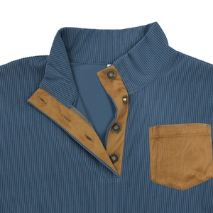 Detail of navy corduroy sweatshirt showing contrast brown suede pocket and button collar