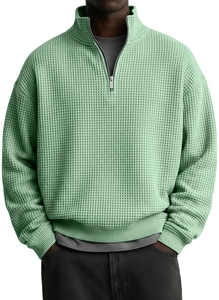 Detail view of men's waffle knit sweatshirt with quarter-zip stand collar and texture