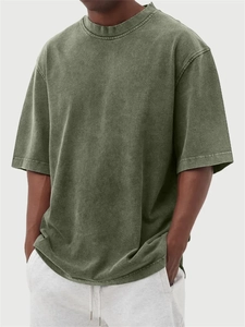 Close-up of olive green washed cotton fabric texture on oversized vintage men's T-shirt