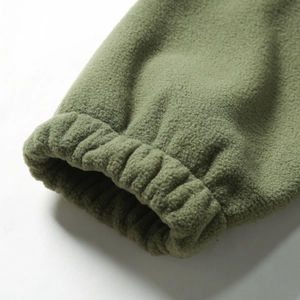 Detail of army green fleece pullover showing ribbed elastic cuffs and soft grainy texture
