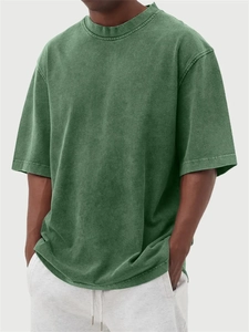 Close-up of vintage washed dark green heavy cotton t-shirt with retro faded texture