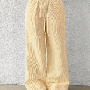 Women's yellow and white striped wide-leg pants with adjustable drawstring waist