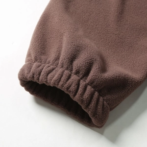 Detail shot of heavy brown fleece jacket featuring elastic cuffs for windproof warmth