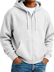 Detailed macro view of men's white waffle-knit fabric and silver zipper on the hoodie