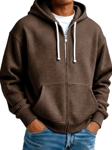 Detail of coffee brown waffle knit texture on men's zip-up hoodie with white drawstrings