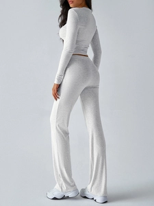 Detailed side view of light grey long sleeve yoga top and flare pants set for women