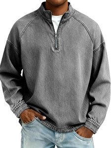 Detail of vintage washed gray half-zip sweatshirt with stand collar and raglan sleeve seams
