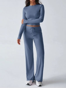Detail of grey-blue long sleeve crop top and high-waisted wide-leg yoga pants set