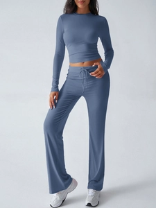 Detail of blue long-sleeve crop top and high-waisted wide-leg yoga pants set