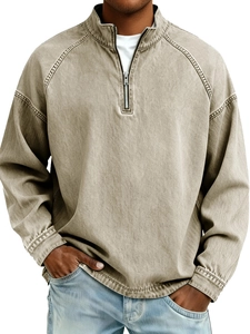 Detailed close-up of vintage washed cotton fabric and high-quality metal half-zipper collar