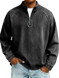 Detailed view of gray washed denim pullover featuring stand collar and white contrast stitching