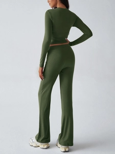 Back view of dark green slim-fit long sleeve top and flare yoga pants sport set
