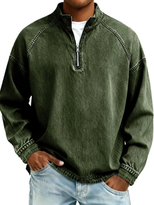 Detail of vintage army green half-zip sweatshirt with retro washed texture and stand collar