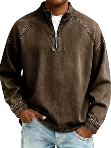 Detailed close-up of brown washed vintage men's sweatshirt with half-zip stand collar