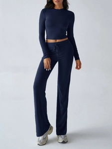 Detail view of navy blue long sleeve top and high waist drawstring wide leg pants set