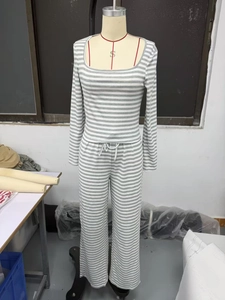 Detail of grey striped knit two-piece set featuring square neck top and drawstring pants
