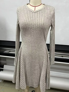 Detail view of oatmeal knitted A-line dress with long sleeves and ribbed texture