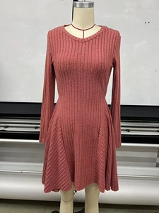 Detailed view of dusty rose knitted dress showing vertical ribbed texture and soft fabric
