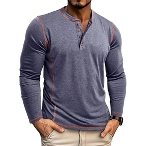 Detail of grey-blue Henley shirt featuring orange contrast stitching and buttoned placket