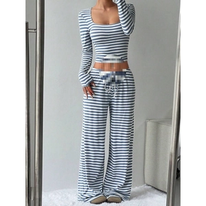 Detail of blue and white striped knit set showing high waist drawstring and ribbed texture