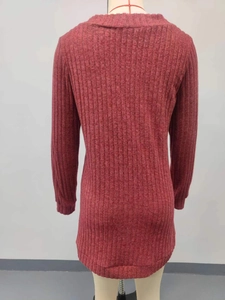 Macro detail of the vertical ribbed texture on this dark pink knitted long sleeve cardigan